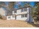 Newly renovated two-story house with white siding, black shutters, and a well-maintained lawn at 3344 Creekwood Dr, Rex, GA 30273