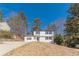 Traditional two-story house with a wide driveway, white siding, and black shutters on a sunny day at 3344 Creekwood Dr, Rex, GA 30273