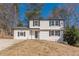 Classic white house with black shutters and a well-manicured lawn, blending traditional charm with modern updates at 3344 Creekwood Dr, Rex, GA 30273