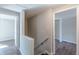 Upstairs hallway features wood-look flooring, handrail, and doorways to other rooms at 3344 Creekwood Dr, Rex, GA 30273