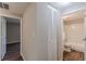 Hallway includes doors to the bedrooms and bathroom with closet and wood look flooring at 3344 Creekwood Dr, Rex, GA 30273