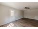 Living room featuring stylish wood-look floors, fan, neutral paint and access to the backyard at 3344 Creekwood Dr, Rex, GA 30273