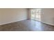 Neutral-toned living room with a sliding door leading to the yard at 3344 Creekwood Dr, Rex, GA 30273