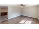 Living room featuring stylish wood-look flooring and a ceiling fan at 3344 Creekwood Dr, Rex, GA 30273
