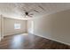 Bright living room with wood-look floors, fan, textured ceiling and access to the backyard at 3344 Creekwood Dr, Rex, GA 30273