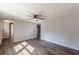 Spacious living room features wood-look flooring and ceiling fan at 3344 Creekwood Dr, Rex, GA 30273