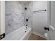 Stylish bathroom featuring marble tile and black fixtures at 3777 Clubhouse Way, Conyers, GA 30094