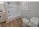 Bright bathroom with a white vanity, matte black fixtures, and tub with white tile surround at 3777 Clubhouse Way, Conyers, GA 30094