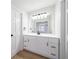 Bathroom boasts white vanity with modern fixtures, a large mirror, and plenty of storage at 3777 Clubhouse Way, Conyers, GA 30094