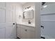 Bright bathroom with a white vanity, matte black accents, and tub with white tile surround at 3777 Clubhouse Way, Conyers, GA 30094