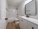 Bright bathroom with a white vanity, matte black accents, and tub with white tile surround at 3777 Clubhouse Way, Conyers, GA 30094