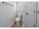 Small powder room with white toilet, white door and dark hardware at 3777 Clubhouse Way, Conyers, GA 30094