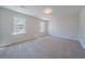 Bedroom features carpet flooring and natural light from two large windows at 3777 Clubhouse Way, Conyers, GA 30094
