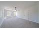 Spacious carpeted bedroom with natural light from two windows and a ceiling fan at 3777 Clubhouse Way, Conyers, GA 30094