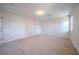 Spacious bedroom featuring neutral carpet, a white wall color, and a bright window at 3777 Clubhouse Way, Conyers, GA 30094