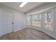 Bonus room with bay windows and wood-look flooring offers natural light and exterior views at 3777 Clubhouse Way, Conyers, GA 30094