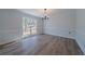Inviting dining room with hardwood floors, wainscoting, and a large window with natural light at 3777 Clubhouse Way, Conyers, GA 30094