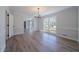 Bright dining room featuring hardwood floors, a modern chandelier, and a large window for natural light at 3777 Clubhouse Way, Conyers, GA 30094