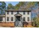 Traditional two-story home featuring a brick foundation and a welcoming front porch entrance with stairs at 3777 Clubhouse Way, Conyers, GA 30094