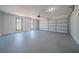 A spacious two car garage featuring updated windows, lighting and concrete floor at 3777 Clubhouse Way, Conyers, GA 30094