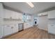 Modern kitchen with white cabinets, stainless steel appliances, quartz countertops, and hardwood floors at 3777 Clubhouse Way, Conyers, GA 30094