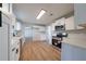 Bright kitchen features stainless steel appliances, white cabinets and countertops, and modern fixtures at 3777 Clubhouse Way, Conyers, GA 30094
