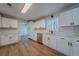 Bright kitchen featuring white cabinets, stainless steel appliances, hardwood flooring and quartz countertops at 3777 Clubhouse Way, Conyers, GA 30094