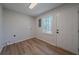 Laundry room area features wood-look flooring and natural light from a window at 3777 Clubhouse Way, Conyers, GA 30094