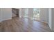 Open living room features wood-look flooring, a staircase, and natural light from two windows at 3777 Clubhouse Way, Conyers, GA 30094
