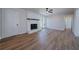 Bright living room featuring a white brick fireplace, ceiling fan, and hardwood floors at 3777 Clubhouse Way, Conyers, GA 30094