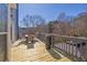 Relaxing outdoor deck featuring a dining table, a grill, and a peaceful view of the backyard at 4229 Gold Springs Ln, Hoschton, GA 30548