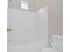 All-white bathroom with shower and tub at 627 W Oaks Dr, Woodstock, GA 30188