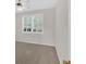 Bedroom featuring large window with shutter style blinds and neutral carpet at 627 W Oaks Dr, Woodstock, GA 30188