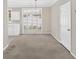 Open dining area with neutral tones, large windows, and an elegant chandelier at 627 W Oaks Dr, Woodstock, GA 30188