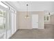 Bright dining area featuring a chandelier, plantation shutters, and light-colored walls at 627 W Oaks Dr, Woodstock, GA 30188