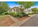 Home exterior showcasing well-maintained landscaping with lush shrubs, a sidewalk, and a stone accent wall at 627 W Oaks Dr, Woodstock, GA 30188