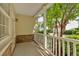 Charming front porch featuring stone accents, white railing, and lush greenery, offering a welcoming entrance at 627 W Oaks Dr, Woodstock, GA 30188