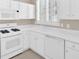 A close-up view of the kitchen offering a full range of modern white appliances at 627 W Oaks Dr, Woodstock, GA 30188