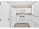 Bright kitchen featuring white appliances, cabinetry, and modern fixtures providing a clean aesthetic at 627 W Oaks Dr, Woodstock, GA 30188