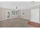 Inviting living room with abundant natural light, complemented by neutral tones and smooth carpets at 627 W Oaks Dr, Woodstock, GA 30188