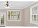 Bright living area featuring light-colored walls, plantation shutters and a ceiling fan with lighting fixture at 627 W Oaks Dr, Woodstock, GA 30188