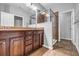 Bathroom featuring a double sink vanity with tile flooring and a glass enclosed shower at 1992 Cobblestone Ne Cir, Brookhaven, GA 30319