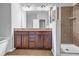 Bathroom featuring a double sink vanity with tile flooring and a glass enclosed shower at 1992 Cobblestone Ne Cir, Brookhaven, GA 30319