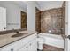 Bathroom with a tiled shower and tub combo, vanity, and white cabinets at 1992 Cobblestone Ne Cir, Brookhaven, GA 30319