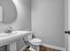 Powder room featuring a white pedestal sink and toilet at 1992 Cobblestone Ne Cir, Brookhaven, GA 30319