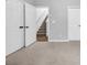 Bedroom featuring neutral walls and carpet, as well as access to a closet and stairs at 1992 Cobblestone Ne Cir, Brookhaven, GA 30319