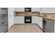 Well-lit kitchen featuring stainless steel appliances, granite countertops, and white cabinets at 1992 Cobblestone Ne Cir, Brookhaven, GA 30319