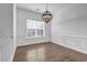 Living room featuring hardwood floors, white trim, wainscotting and a large window at 1992 Cobblestone Ne Cir, Brookhaven, GA 30319