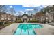 Community pool with lounge area and gated entrance surrounded by lush landscaping at 1992 Cobblestone Ne Cir, Brookhaven, GA 30319