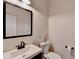 Modern powder room with stylish vanity, mirror, and decor at 3202 Monarch Pine Dr, Peachtree Corners, GA 30071